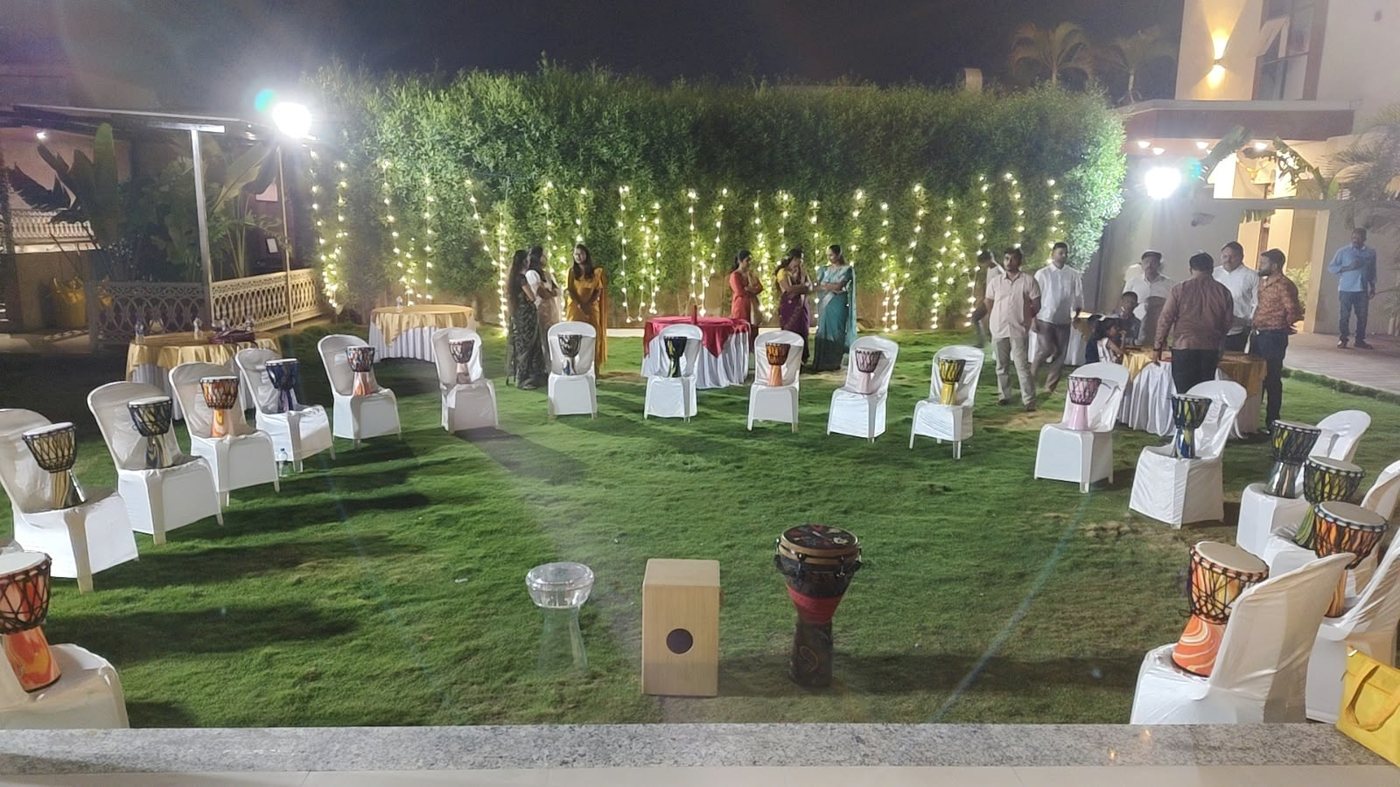 Drum circle set-up on a lit garden lawn at night